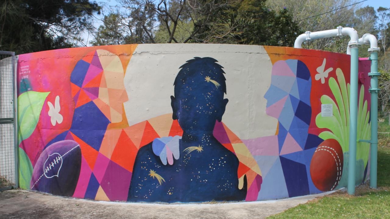 Two water tanks at the Hanging Rock Oval were painted as part of the mural. Picture: Tom McGann