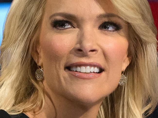 In this Thursday, Aug. 6, 2015 photo, Fox News moderators Megyn Kelly, right, listens as Chris Wallace, begins introductions during the first Republican presidential debate at the Quicken Loans Arena, in Cleveland. Angry over what he considered unfair treatment at the debate, republican presidential candidate Donald Trump told CNN on Friday night that Kelly had "blood coming out of her eyes, blood coming out of her wherever." (AP Photo/John Minchillo)