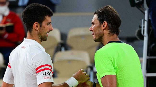 Serbia's Novak Djokovic (L) and Spain's Rafael Nadal shake hands at the end of their men's singles semi-final tennis match at the 2021 French Open tennis tournament in Paris in June.