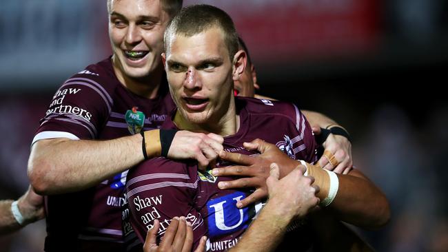 Tom Trbojevic of the Sea Eagles celebrates with his team mates after scoring a try.