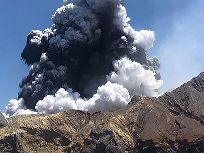 TOPSHOT - This handout photo taken on December 9, 2019 and provided courtesy of Lillani Hopkins through her Facebook account on December 12 shows a plume of ash rising into the air as the volcano on White Island erupts off the coast of Whakatane on New Zealand's North Island. - Hopkins and her father left the island just as it erupted and their boat went back to help pick up those injured in the blast. New Zealand authorities will mount a dangerous mission to retrieve remains from the still-seething White Island volcano on December 13, amid mounting pressure from distraught victims' families. (Photo by Handout / COURTESY OF LILLANI HOPKINS / AFP) / -----EDITORS NOTE --- RESTRICTED TO EDITORIAL USE - MANDATORY CREDIT "AFP PHOTO / COURTESY OF LILLANI HOPKINS " - NO MARKETING - NO ADVERTISING CAMPAIGNS - DISTRIBUTED AS A SERVICE TO CLIENTS - NO ARCHIVES