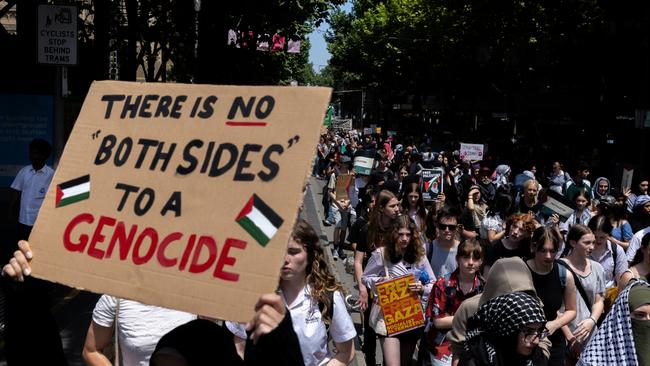 Protesters hold placards denouncing the ‘genocide’. Picture: Getty Images