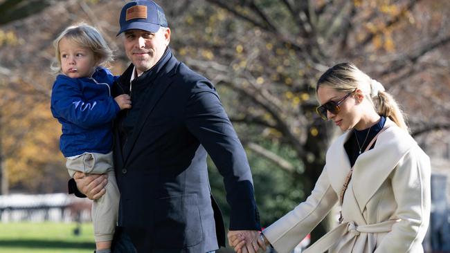 Hunter Biden carries his son Beau alongside his wife Melissa Cohen, as they disembark from Marine One at the White House. Picture: AFP.