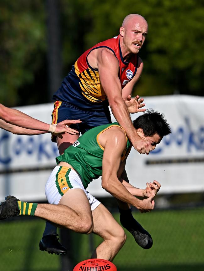 Johnson crashes a pack while playing for Yarraville-Seddon. Picture: Andy Brownbill