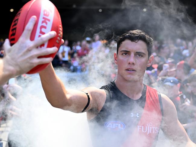 MELBOURNE, AUSTRALIA - MARCH 16: Jye Caldwell of the Bombers runs out onto the field during the round one AFL match between Essendon Bombers and Hawthorn Hawks at Melbourne Cricket Ground, on March 16, 2024, in Melbourne, Australia. (Photo by Quinn Rooney/Getty Images)