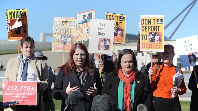 Biloela locals Angela Fredericks, who has travelled to Christmas Island to see the family, and Bronwyn Dendle, whose children played with Kopika and Tharunicaa in Biloela and Canberra supporters of the campaign, out the front of Parliament House in Canberra with a petition of 250k signatures. Picture Kym Smith