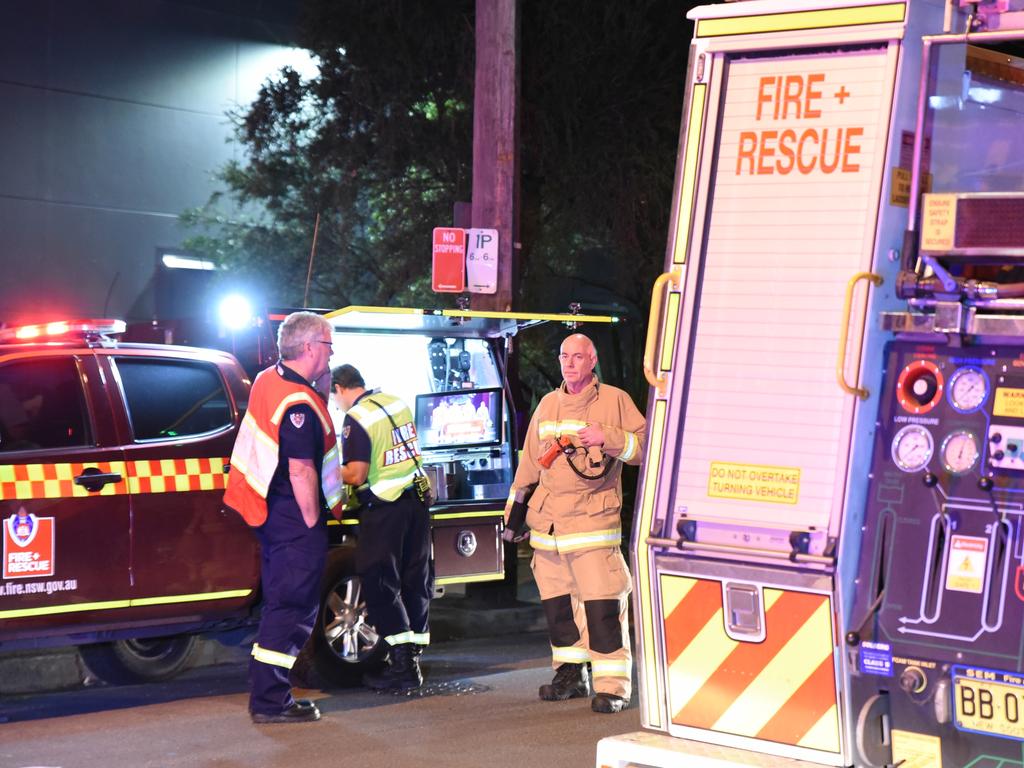 Police and Fire and Rescue NSW firefighters evacuate Mascot Towers residents. Picture: Flavio Brancaleone