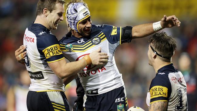 Ethan Lowe celebrates a try with Johnathan Thurston and Michael Morgan.