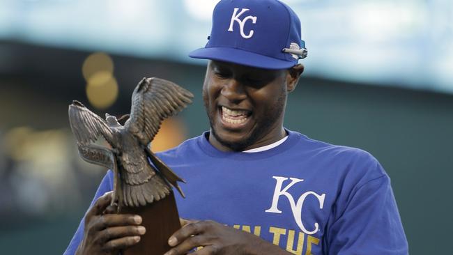 Lorenzo Cain picks up his MVP trophy after the Royals defeated the Baltimore Orioles to win the American League.