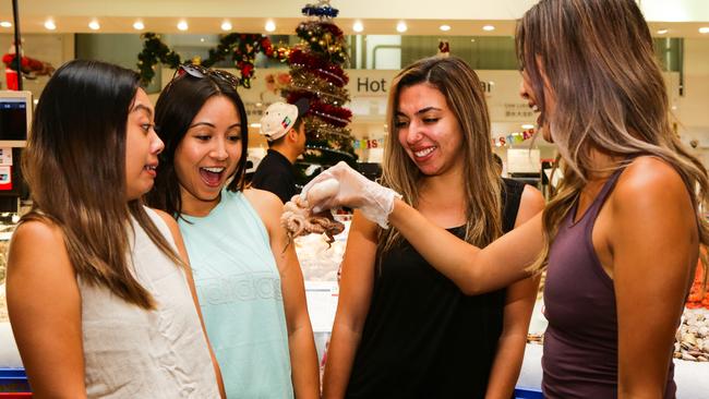 Tourist Querida Xie from California and her girlfriends sample the octopus.