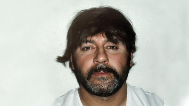 Tony Mokbel in his wig in Athens before extradition to Australia. Picture: AFP