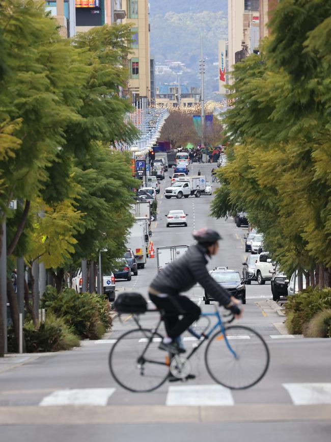 A cyclist in Adelaide’s CBD. Hindley St looking east. Picture: Russell Millard