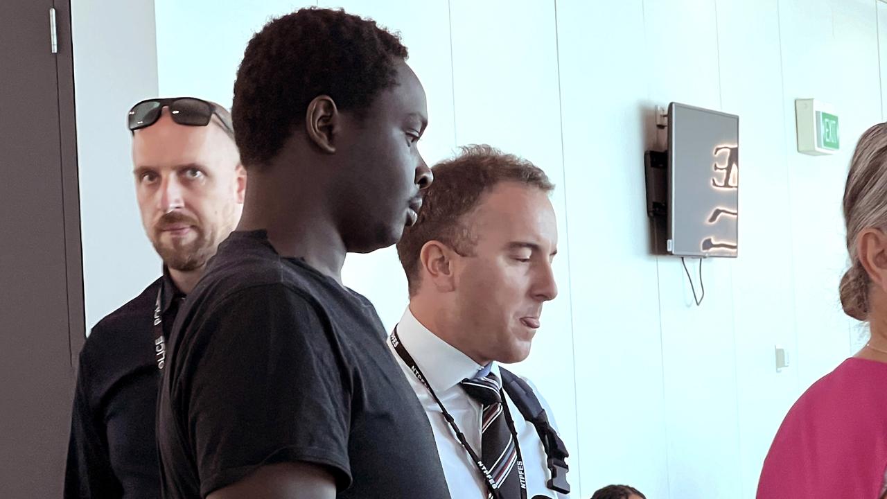 On January 15, 2024, Koang Wuordol, arrested over the murder of Sudanese teenager Yiel Gatluak, boards a Qantas flight at Melbourne Airport, and is extradited to Alice Springs. PICTURE: NCA Newswire / Nicki Connolly