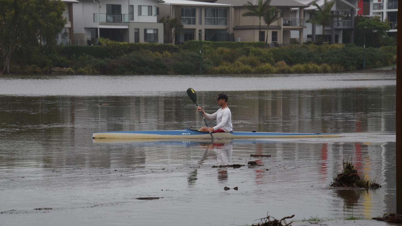 The flooding did not deter a kayaker from Lake Orr at Varsity Lakes. Picture: Steve Holland