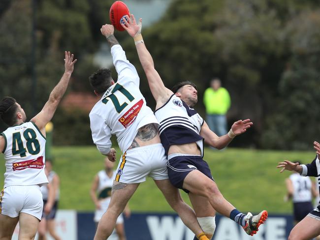 Daniel Guccione (right) flies in the ruck for Bundoora. Picture: Ian Currie. 