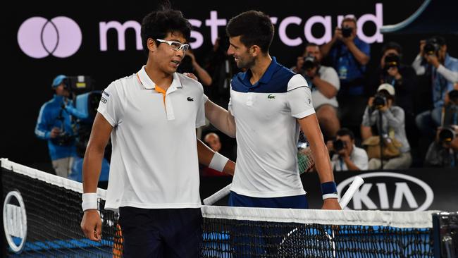 Hyeon Chung speaks with Novak Djokovic after their fourth-round Australian Open match. Photo: Paul Crock/AFP