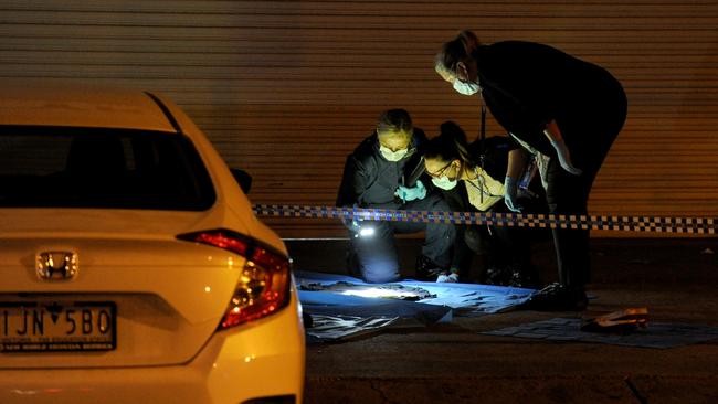 Police at the scene of a Sunday’s murder in which 20-year-old Winis Apet was shot and killed outside a Springvale cafe. Picture: Andrew Henshaw