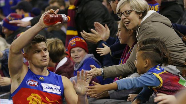 Captain Dayne Zorko enjoys the spoils of Brisbane’s win with the club’s fans. Picture: AAP Image/Daniel Pockett.