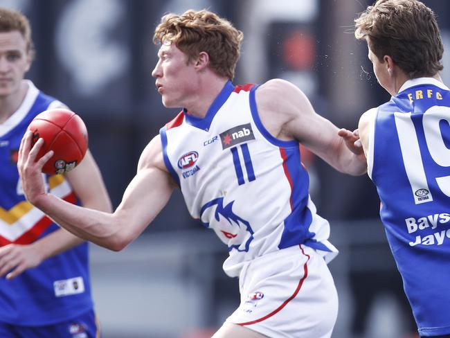 MELBOURNE, AUSTRALIA - SEPTEMBER 21: Matthew Rowell of the Chargers handpasses the ball whilst being tackled during the NAB League Grand Final match between Eastern Ranges and Oakleigh Chargers at Ikon Park on September 21, 2019 in Melbourne, Australia. (Photo by Daniel Pockett/AFL Photos/via Getty Images)