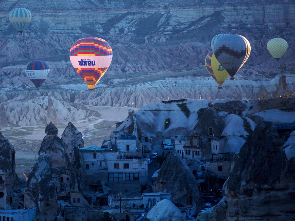 Tourists ride hot air balloons near the town of Goreme on April 17, 2016 in Nevsehir, Cappadocia, Turkey. Picture: Getty