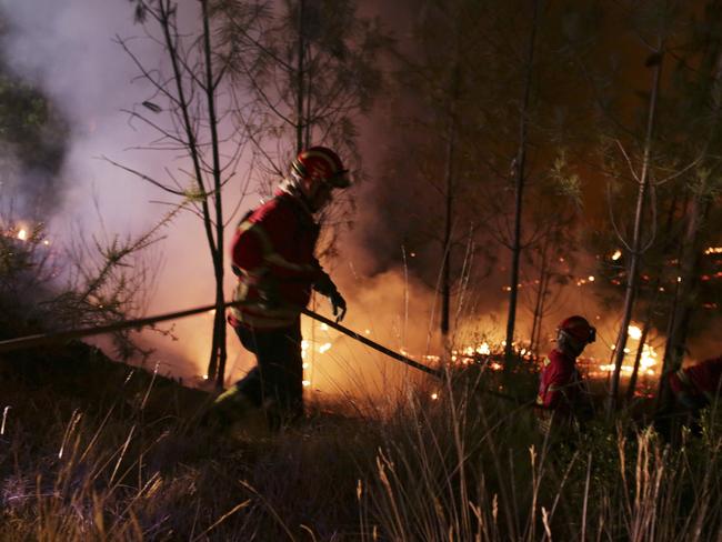Firefighters move down a slope to contain a forest fire on the hills near Abrantes, central Portugal, Thursday night, Aug. 10, 2017. Wildfires flared across Portugal on Thursday following a rise in temperatures and strong winds, ending days of cooler weather that had brought a brief respite from a spate of blazes. Picture: Armando Franca/AP