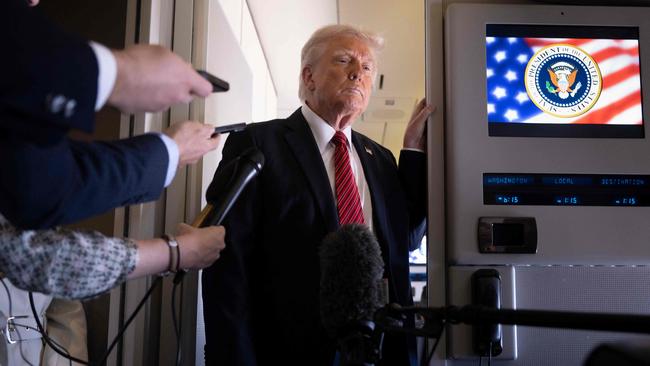 Donald Trump listens to questions as he speaks to members of the press on Air Force One while flying over Saudi Arabia on his way to Qatar. Picture: Brendan Smialowski / AFP