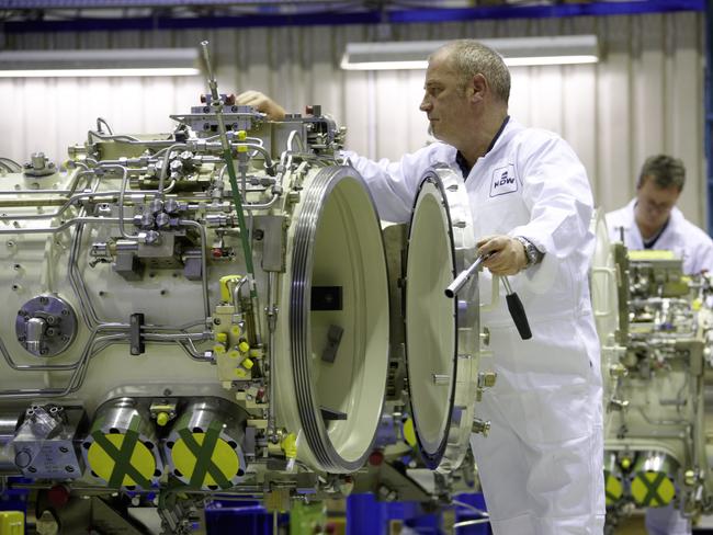 Opened it doors ... Skilled workers put the finishing touches to torpedo tubes at the ThyssenKrupp Marine Systems submarine building facility in Kiel. Picture: TKMS