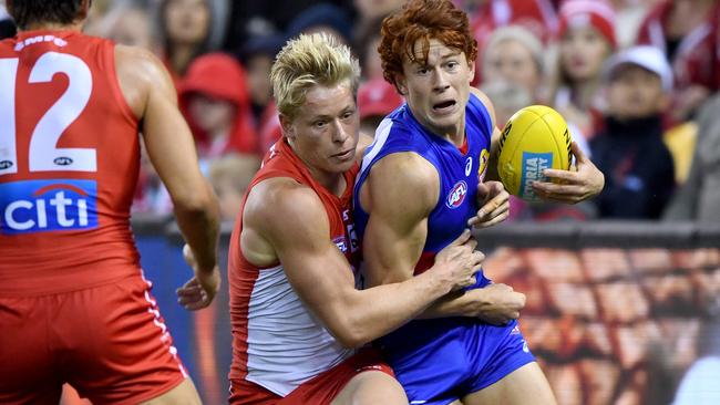 Isaac Heeney tackles Ed Richards.