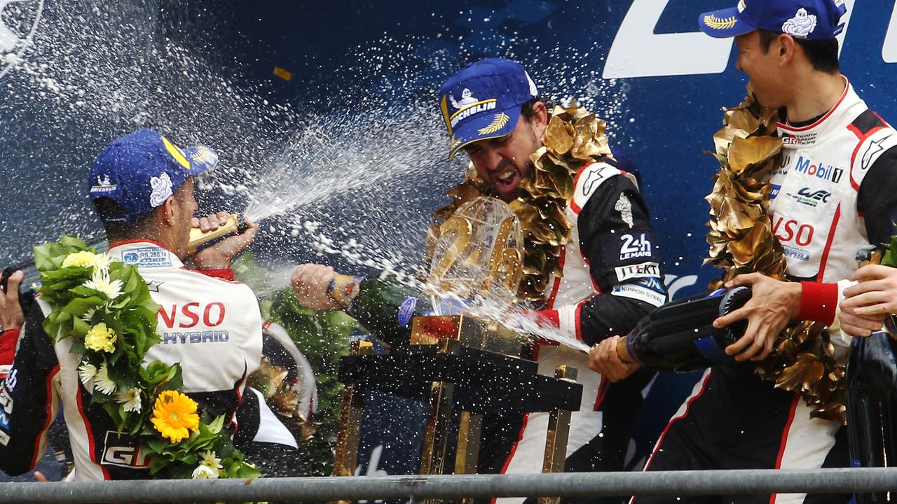Sebastien Buemi, Fernando Alonso and Kazuki Nakajima celebrate winning the Le Mans 24 Hour Race.