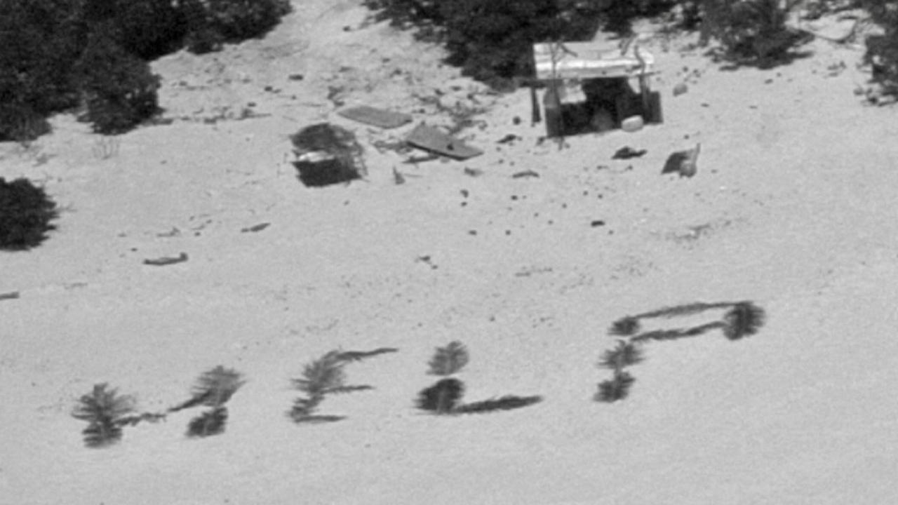 The "HELP" sign on the island beach, made with palm leaves by three mariners stranded on Pikelot Atoll, was spotted from the air. Picture: AFP Photo/handout/US Coast Guard