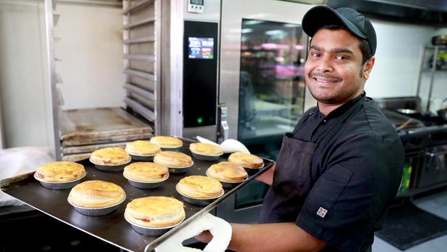 Come and get them: Sazal Alam with the pies. Picture: Angelo Velardo