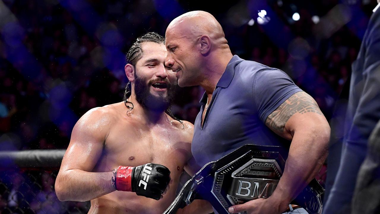 Dwayne "the Rock" Johnson hands UFC star Jorge Masvidal a belt. Masvidal could be next in line to replace Conor McGregor as the organisation’s face.