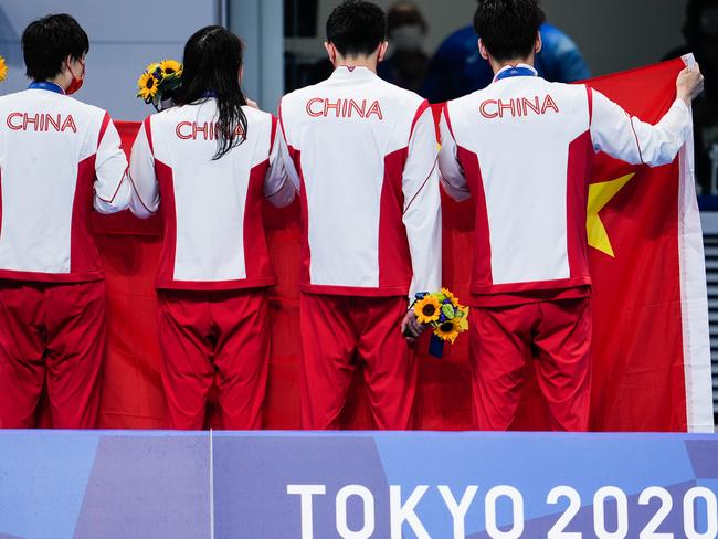 TOKYO, JAPAN - JULY 31: (R- L) Silver medalists Xu Jiayu, Yan Zibei, Zhang Yufei and Yang Junxuan of Team China celebrate with a Chinese national flag after the Mixed 4Ã100 metres medley relay medal ceremony on day eight of the Tokyo 2020 Olympic Games at Tokyo Aquatics Centre on July 31, 2021 in Tokyo, Japan. (Photo by Wei Zheng/CHINASPORTS/VCG via Getty Images)