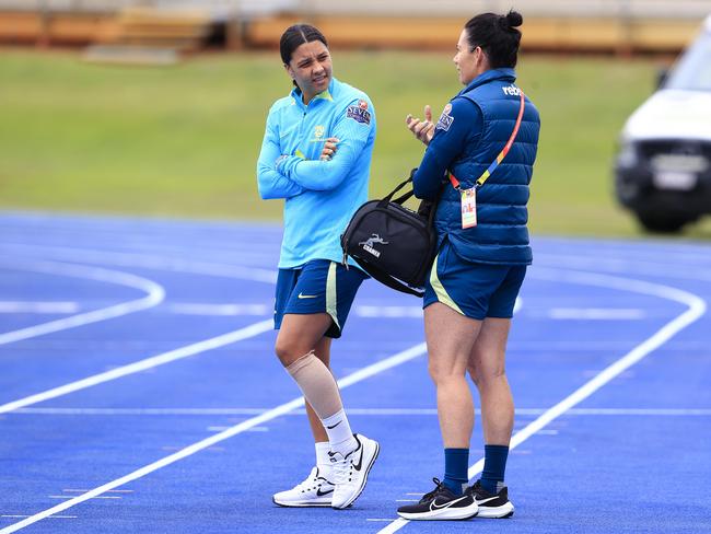 Injured Matildas skipper Sam Kerr (left) chats to a team medico at training. Picture: Adam Head