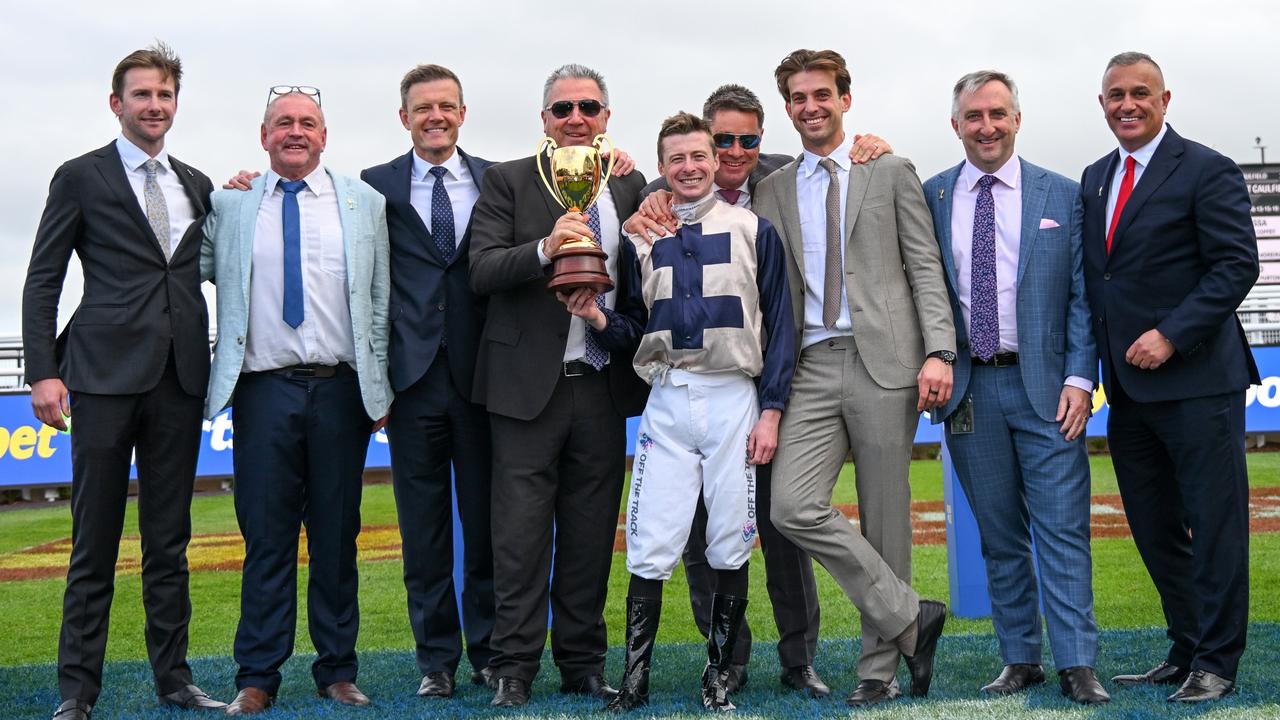 John Kanga (far right) poses with the connections of Caulfield Cup winner Duke De Sessa. Picture: Vince Caligiuri / Getty Images