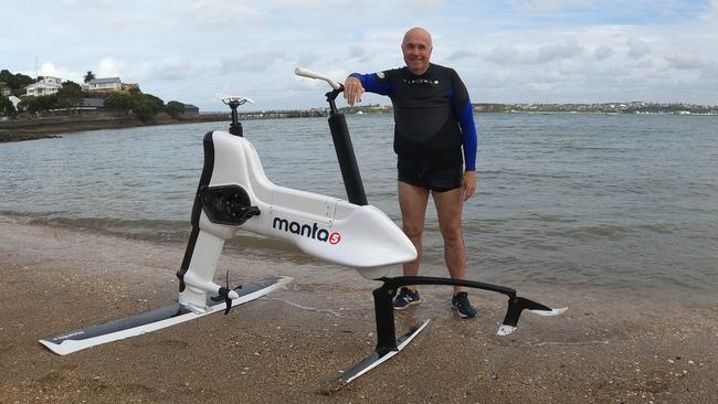 Technology journalist at The Australian Chris Griffith test rides the Hydrofoiler XE-1 by Manta5, an electric bike that planes across water, at Devonport beach in Auckland, New Zealand.