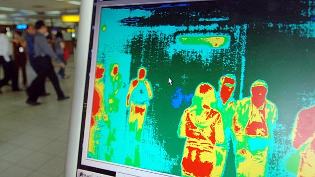  Images from a thermal imaging scanner are pictured on a computer screen as airplane passengers are screened for high tempera...