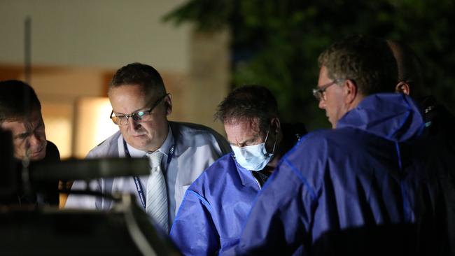 Police comb the area in front of the Upper Coomera house where two bodies were found. Picture Glenn Hampson