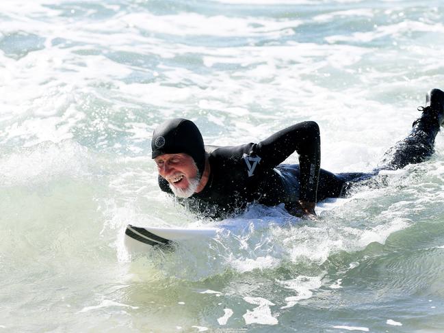 He still enjoys surfing even after his horrific attack. Picture: Peter Lorimer