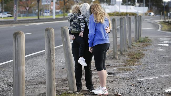 A Sunbury mum and her kids, aged 4 and 11, stand in the spot their car was rammed during the incident. Picture: David Caird