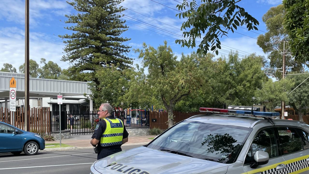 The police officer takes photos near Sunrise Christian School after a child was struck by a car. Picture: Dylan Hogarth