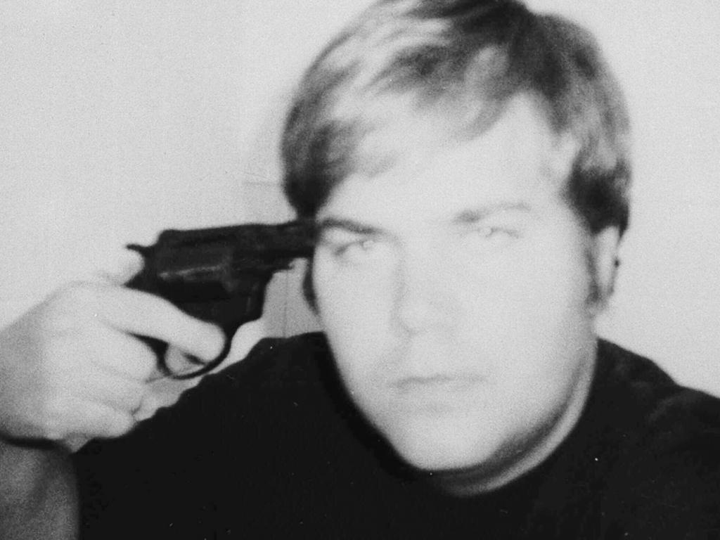 John Hinckley holds a pistol to his head in this self portrait obtained by Associated Press from court records in Washington.