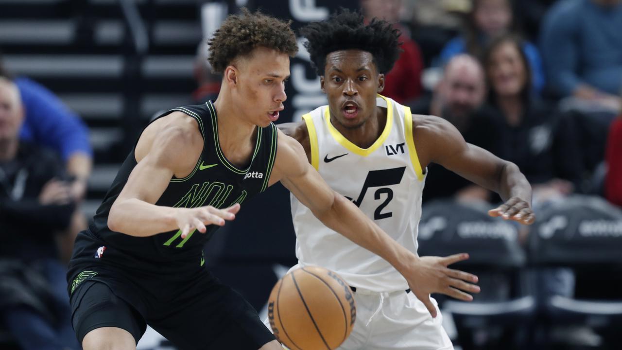 Dyson Daniels pushes the ball past Collin Sexton. (Photo by Chris Gardner/Getty Images)