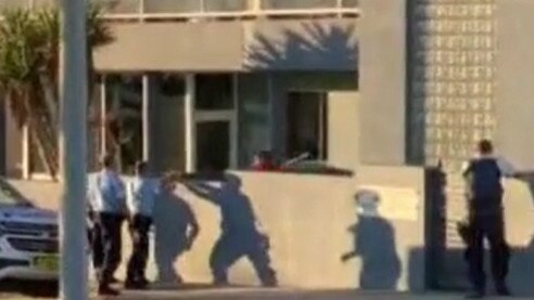 John Collins is seen in a stand-off with police at Bar Beach in December 2019, telling them he was the "ultimate fighter". Credit: NBN News