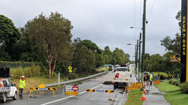 Gold Coast City Council cleaning up on Tuesday morning after flooding on Siganto Drive at Helensvale. Picture: Keith Woods