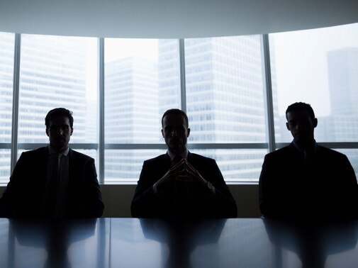 Silhouette row of businessmen sitting in meeting roomMen boardroom business company directors