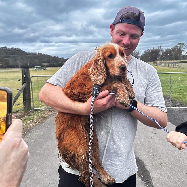 Lachlan Carter, with pet cocker spaniel Goldie, minutes after he managed to grab her after she was spotted by members of the public north of Cobbity on Friday evening. Picture: Supplied