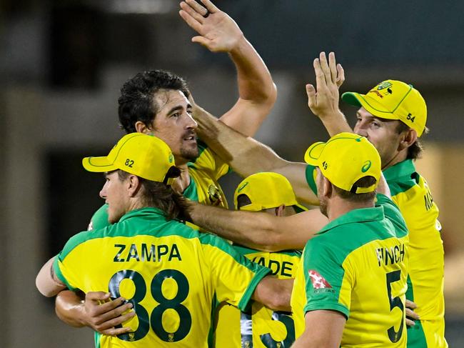 Mitchell Starc (L) of Australia celebrates with teammates winning the 4th T20I between Australia and West Indies at Darren Sammy Cricket Ground, Gros Islet, Saint Lucia, on July 14, 2021. (Photo by Randy Brooks / AFP)