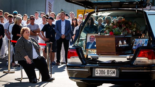 Vili Milisits’ wife Rosemary with her husband’s hearse, surrounded by staff at his Mile End South bakery, before the legendary baker’s funeral. Picture: Matt Turner