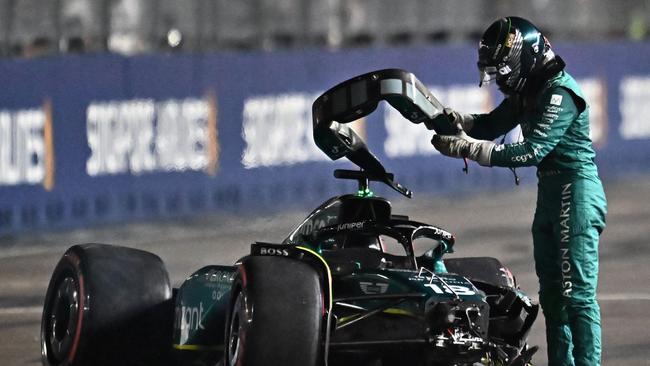 TOPSHOT – Aston Martin's Canadian driver Lance Stroll gets out of his car after crashing during the qualifying session of the Singapore Formula One Grand Prix night race at the Marina Bay Street Circuit in Singapore on September 16, 2023. (Photo by Lillian SUWANRUMPHA / AFP)